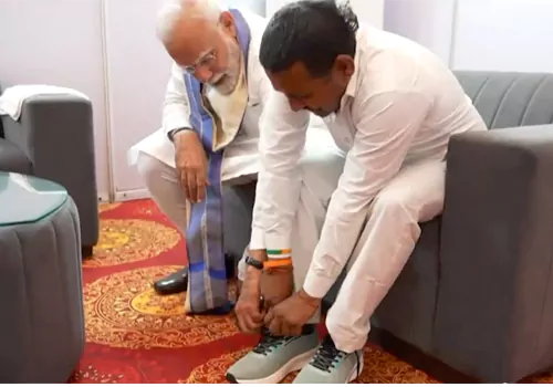 prime minister modi put shoes to his fan