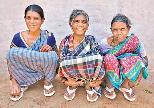 pawan gives footwear to tribals