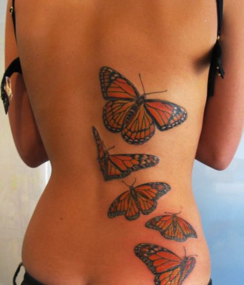 Lower back butterfly tattoo with forget me not flowers  Lower back tattoos  Butterfly tattoos for women Tattoo styles